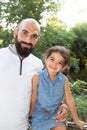 Playfull daughter child with bald man father outdoor