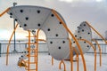 Playground against snowy landscape and cloudy sky