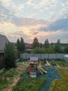 playground in the backyard. sunset in the distance.