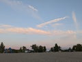 Playground beach sand yellow sunset clouds blue pink lights trees green beautiful Royalty Free Stock Photo