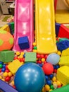 Playground, children`s slides, a play area of colorful plastic balls. Cheerful children`s leisure with balls in the play pool, o Royalty Free Stock Photo