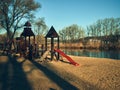 Playground for children, slides and swings, stand on the river bank, late autumn Royalty Free Stock Photo