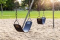 Playground for children with swings in the public park during sunset Royalty Free Stock Photo