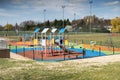 A playground for children to play. Colorful play sets and a safe surface. Coniferous tree branch with cones. Pine.