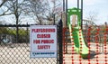 Playground closed for public safety sign posted with orange netting closing the opening of play area Royalty Free Stock Photo