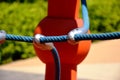 Playground detail with blue ropes of climber and metal clips.