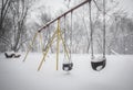 A blizzard buries playground equipment in snow. Royalty Free Stock Photo