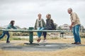 Playground, family and happy people in a nature play park with a mom, child and grandparents. Mother with children