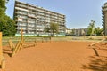 a playground in front of a building in a park Royalty Free Stock Photo