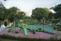 A playground at a garden park with slides, climbers stairs and playhouse Royalty Free Stock Photo