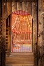 On the playground - inside a rustic wooden climbing tower looking out at orange rope tunnel to climb Royalty Free Stock Photo