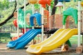Playground for kid children having fun with colorful slide at yard activities in public park Royalty Free Stock Photo