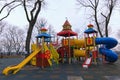 Playground for little kids in the park. An empty children`s playground is waiting for children. The early foggy morning