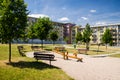 Playground in nature in front of row of newly built block of flats Royalty Free Stock Photo