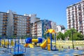 Playground and outdoor fitness equipment in colors of La Boca Juniors in front of family dwelling in La Boca, Buenos Aires