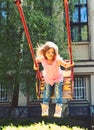 Playground in park. childhood daydream .teen freedom. Happy laughing child girl on swing. Small kid playing in summer Royalty Free Stock Photo