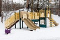 Playground in park without kids, covered with snow in winter season Royalty Free Stock Photo