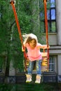 Playground in park. Small kid playing in summer. childhood daydream .teen freedom. Happy laughing child girl on swing Royalty Free Stock Photo