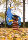 Playground rocking horse in autumn Royalty Free Stock Photo