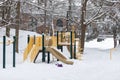 Playground with slide without children, covered with snow in winter season Royalty Free Stock Photo