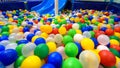 Playground for sport and play in kindergarten. Panoramic view inside the plastic dry pool with many colorful balls and slide Royalty Free Stock Photo