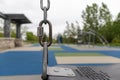 Playground swing chain - close up - play structure blurred background