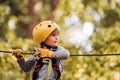 Playground. Toddler climbing in a rope playground structure. Eco Resort Activities. Balance beam and rope bridges