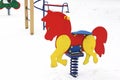 Playground in the winter. Children`s playground in the snow. Children`s swing Royalty Free Stock Photo