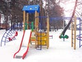 Playground in the winter. Children`s playground in the snow. Children`s swing Royalty Free Stock Photo