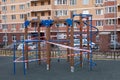 Playground wrapped in striped red white tape, stay home. Quarantine local area, prevention of infection with the covid-19 Royalty Free Stock Photo