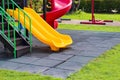 Playground yellow slide in garden outdoor background no children