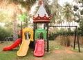 Colorful slider and playhouse at the backyard of the nature setting background Royalty Free Stock Photo