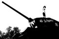 playing on abandoned tank in silhouette