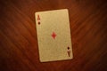 Playing ace card on wooden background, ace of diamonds close up, gold, golden ace card of diamonds Royalty Free Stock Photo
