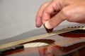 Playing acoustic guitar: hand with pick on strings Royalty Free Stock Photo