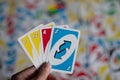 Playing american card game Uno, holding game cards in female hand. Royalty Free Stock Photo