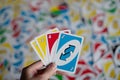 Playing american card game Uno, holding game cards in female hand. Royalty Free Stock Photo