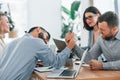 Playing arm wrestling. Group of business people that working on the project in the office Royalty Free Stock Photo