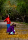 Playing in autumn leaves