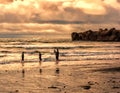 Playing on the beach under winter sunset