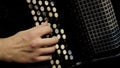 Playing on a big accordion. Playing the harmonica close-up. Old musical instrument Russian bayan - button accordion