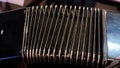 Playing on a big accordion. Playing the harmonica close-up. Old musical instrument Russian bayan - button accordion