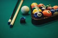 Playing billiard. Billiards balls and cue on green billiards table. Billiard sport concept.