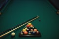 Playing billiard. Billiards balls and cue on green billiards table. Billiard sport concept.