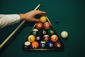 Playing billiard. Billiards balls and cue on green billiards table. Caucasian player put yellow ball inside. Royalty Free Stock Photo