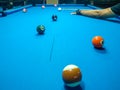 Playing billiard - A shot of a man playing billiard on a blue pool table Royalty Free Stock Photo