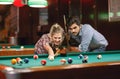 Playing billiards- couple shooting pool ball Royalty Free Stock Photo