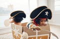 Playing, box ship and pirate children role play, fantasy imagine or pretend in cardboard container. Creative boat, fun Royalty Free Stock Photo