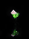 Playing card in a cocktail glass on black background. casino series Royalty Free Stock Photo