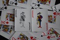 Playing card joker on the background of scattered cards Royalty Free Stock Photo